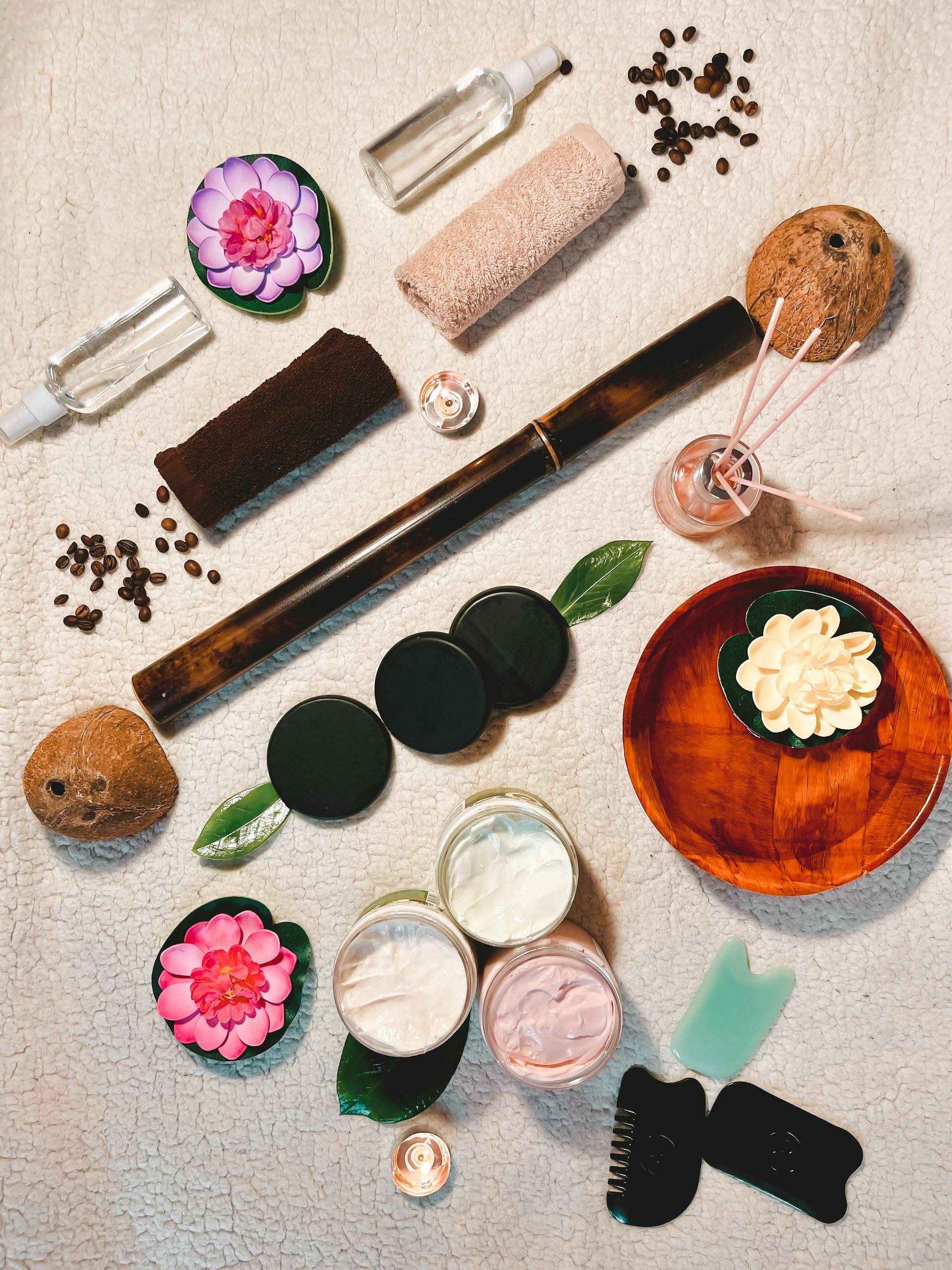 Beautiful flat lay of spa essentials including creams, flowers, and oils.